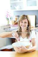 Portrait of a beautiful woman preparing a meal in the kitchen