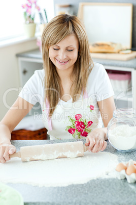 Portrait of a confident woman preparing a cake in the kitchen