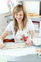 Portrait of a confident woman preparing a cake in the kitchen