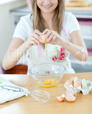Portrait of a smiling woman preparing a cake in the kitchen