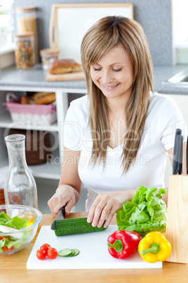 Delighted woman preparing a healthy meal in the kitchen
