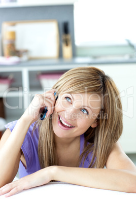 Caucasian woman talking on the phone in the kitchen