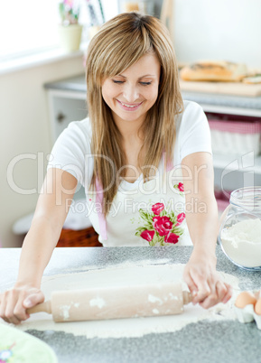 Confident woman preparing a cake in the kitchen