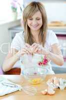 Pretty woman preparing a cake in the kitchen