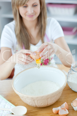 Attractive woman preparing a cake in the kitchen