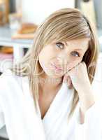 Teen woman looking at the camera in the kitchen