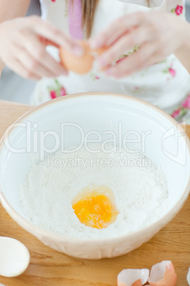 Delighted woman preparing a cake in the kitchen