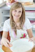 Bright woman preparing a cake in the kitchen