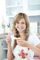 Delighted woman preparing a breakfast in the kitchen