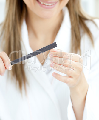 Delighted woman is doing a manicure