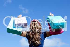 Young woman holding shopping bags outdoor