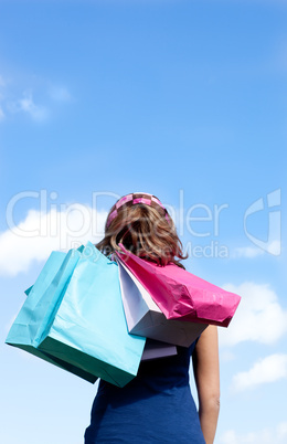 Smiling woman holding shopping bags outdoor