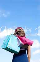 Smiling woman holding shopping bags outdoor
