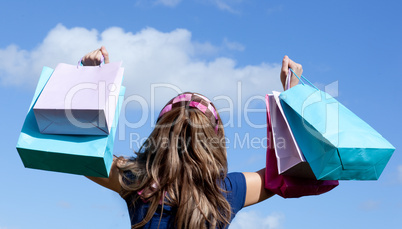 Cute woman holding shopping bags outdoor