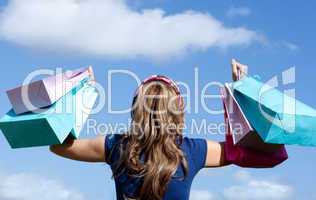 Happy woman holding shopping bags outdoor