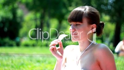 Woman eating potato chips outdoors
