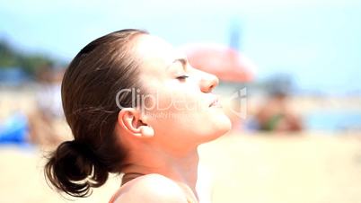 Young woman on the beach during sunbath
