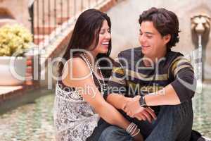 Attractive Hispanic Couple At A Fountain