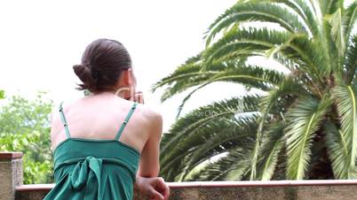 Woman looking at palm trees