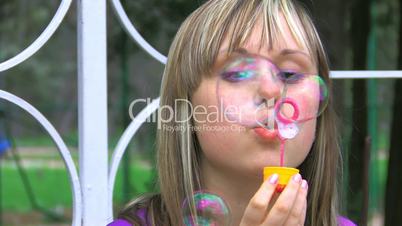 HD Young woman is doing soapbubbles