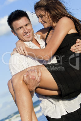 Romantic Couple On Beach With The Man Carrying his Woman