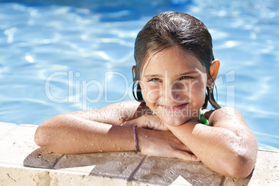 Happy Girl Leaning On The Edge Of A Swimming Pool