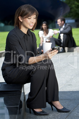 Beautiful Young Chinese Asian Woman Texting and Drinking Coffee