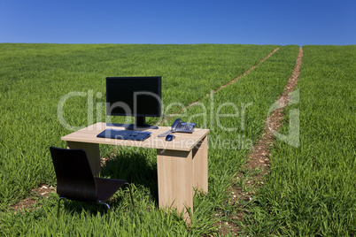 Desk Withh Telephone and Computer In Green Field With Path
