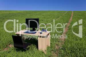 Desk Withh Telephone and Computer In Green Field With Path