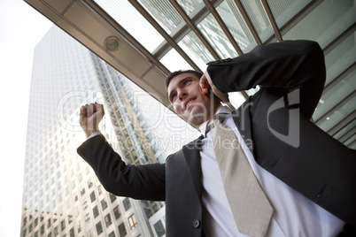 Happy Businessman Celebrating On Cell Phone In The City