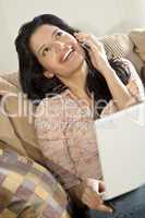 Beautiful Latin Hispanic Woman Using Cell Phone and Laptop Compu