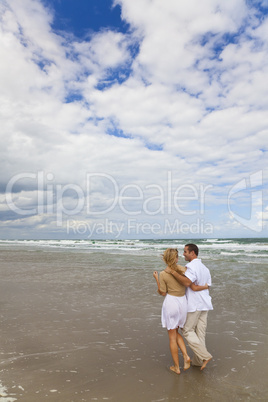 Man and Woman Couple Having Romantic Walk On A Beach