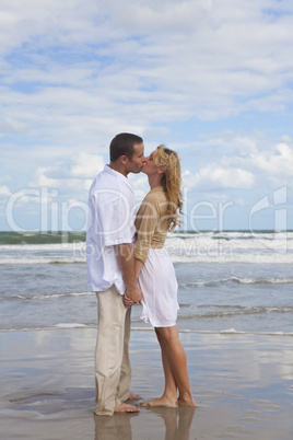 Man and Woman Couple Holding Hands Kissing On A Beach