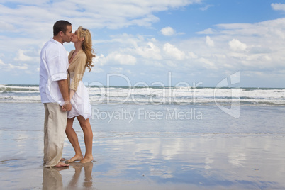 Man and Woman Couple Holding Hands Kissing On A Beach