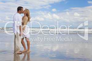 Man and Woman Couple Holding Hands Kissing On A Beach