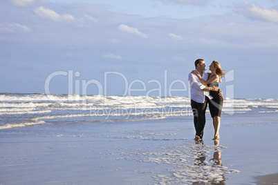 Romantic Man and Woman Couple Walking On A Beach