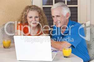 Senior Man and Woman Couple Outside Using Laptop Computer