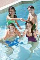 Happy Family With Two Children Playing In A Swimming Pool