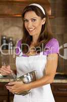 Attractive Woman or American Mom Mixing and Baking In Kitchen