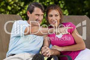 Happy Middle Aged Man Woman Couple Holding Hands and Pointing