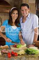 Attractive Man & Woman Couple In Kitchen Making Healthy Sandwich