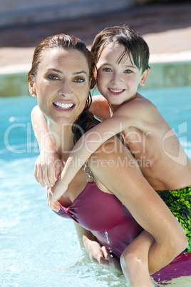 Mother With Son On Her Shoulders In Swimming Pool