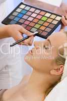 Beautiful Woman Having Make Up Applied by Beautician at Spa