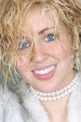Beautiful Young Woman In Fake Fur Coat and Pearls