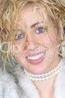 Beautiful Young Woman In Fake Fur Coat and Pearls