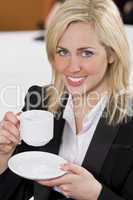 Happy Businesswoman Drinking Coffee In An Office