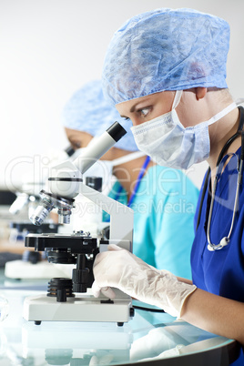 Female Scientific Research Team Using Microscopes in a Laborator