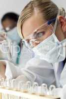 Female Scientific Researcher With Clear Solution In Laboratory