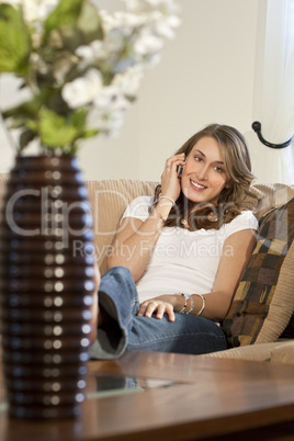 Attractive Young Woman On Her Cell Phone At Home