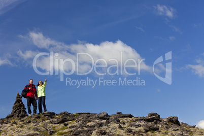 Romantic Couple Hiking Standing Pointing By Stone Pile Tor
